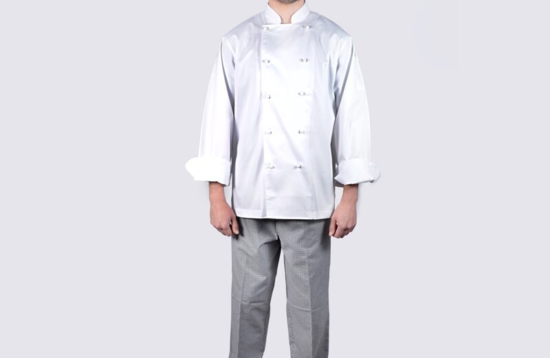 Choosing the right chef jacket: A chef wearing a premium Handy Chef jacket stands confidently in a bustling kitchen, showcasing the perfect blend of comfort and style.